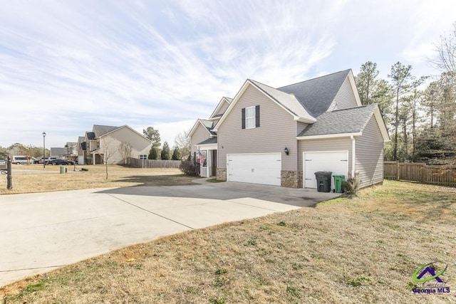 view of home's exterior with a lawn and a garage