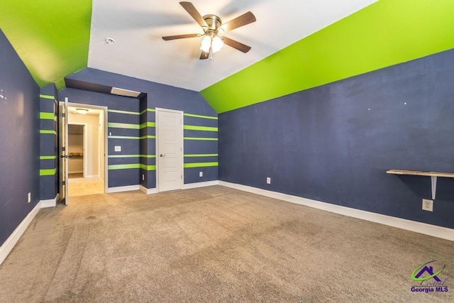 interior space with ceiling fan, vaulted ceiling, and carpet