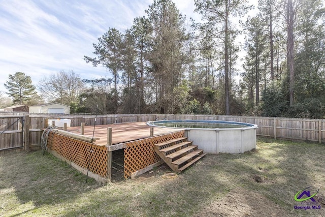 view of pool with a deck and a lawn