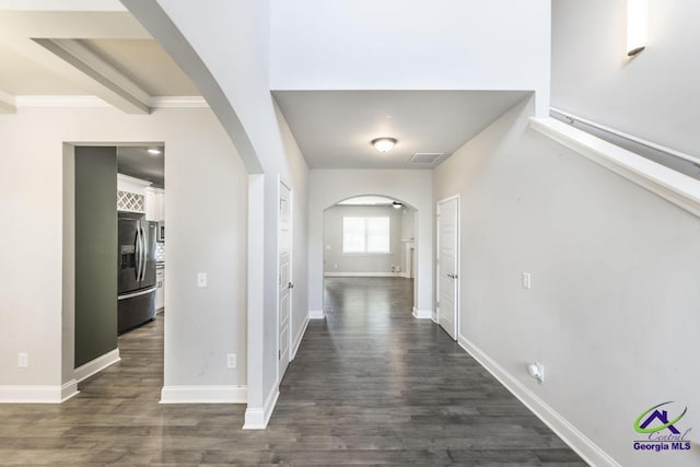 corridor featuring beam ceiling and dark hardwood / wood-style floors