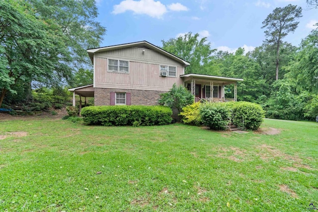 view of home's exterior with a yard and covered porch