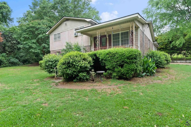 view of side of home with a lawn