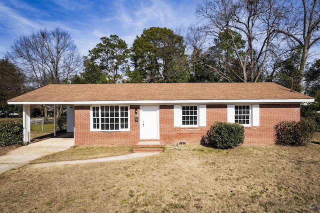 ranch-style house featuring a carport and a front lawn