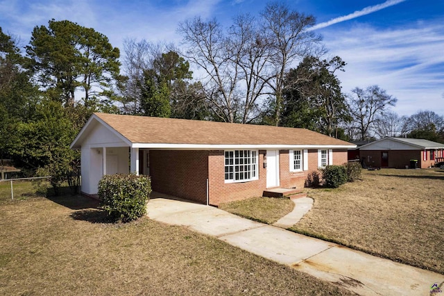 ranch-style house featuring a carport and a front lawn