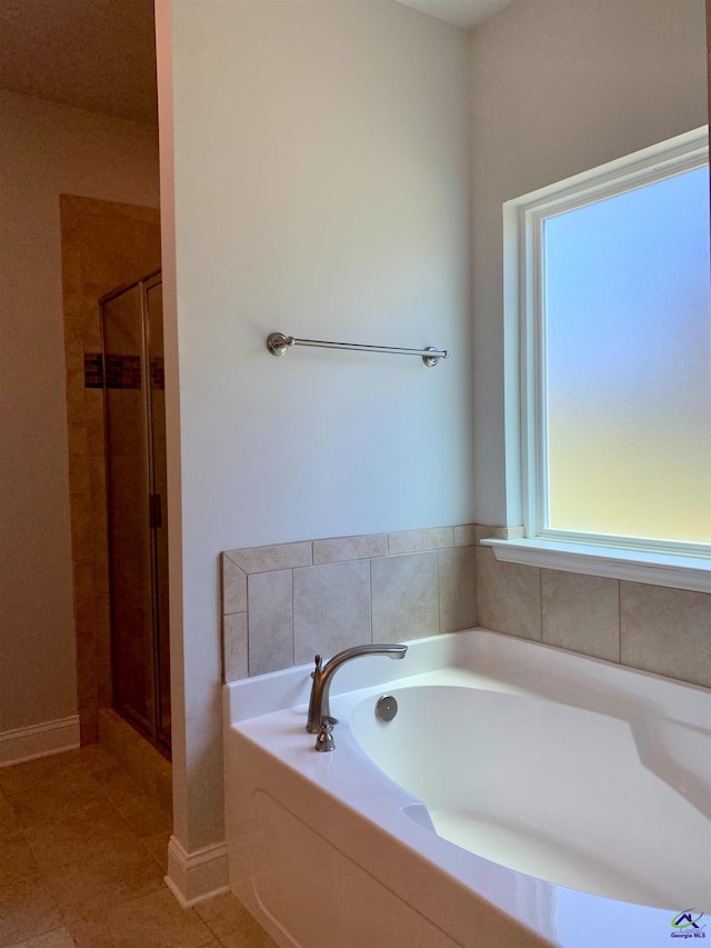 bathroom with tile patterned flooring and plus walk in shower