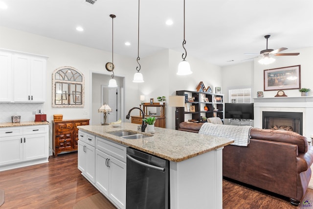 kitchen featuring dishwasher, white cabinetry, sink, hanging light fixtures, and a kitchen island with sink