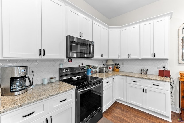 kitchen featuring white cabinetry, appliances with stainless steel finishes, dark wood-type flooring, and decorative backsplash