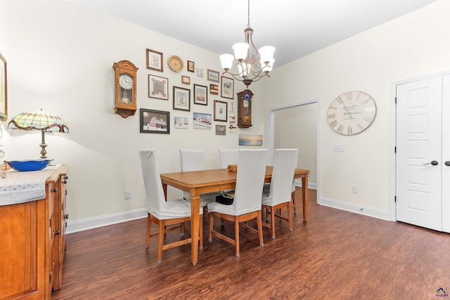 dining space featuring an inviting chandelier and dark wood-type flooring