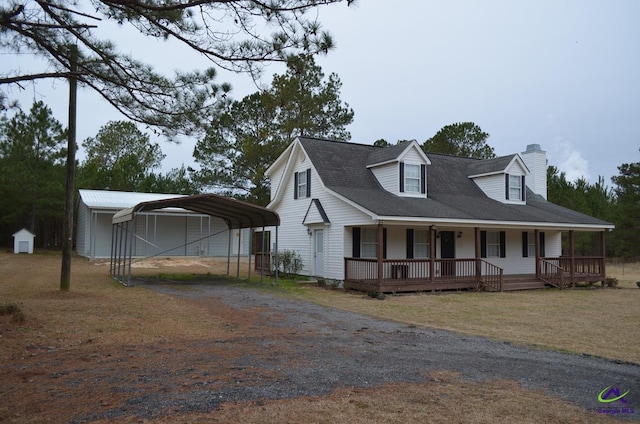 view of front of house featuring a front yard, a porch, and a carport