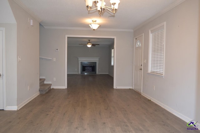 hall with an inviting chandelier, ornamental molding, a textured ceiling, and dark wood-type flooring