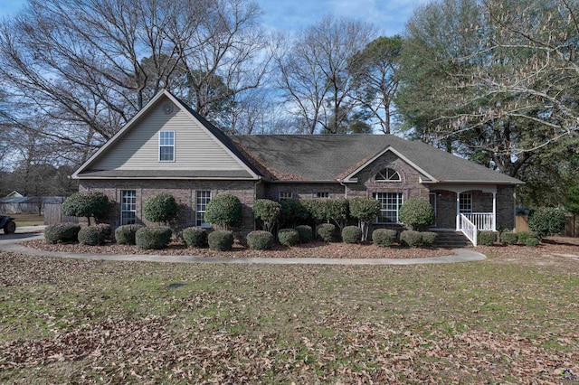 view of front of property with covered porch and a front yard