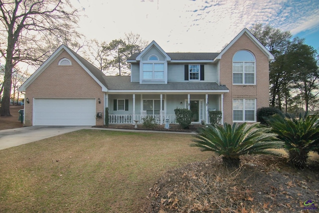 view of front property with a porch, a front yard, and a garage