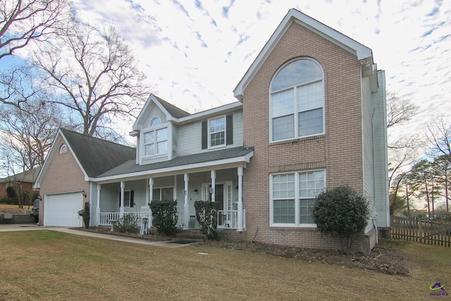 view of front facade with covered porch, a front lawn, and a garage