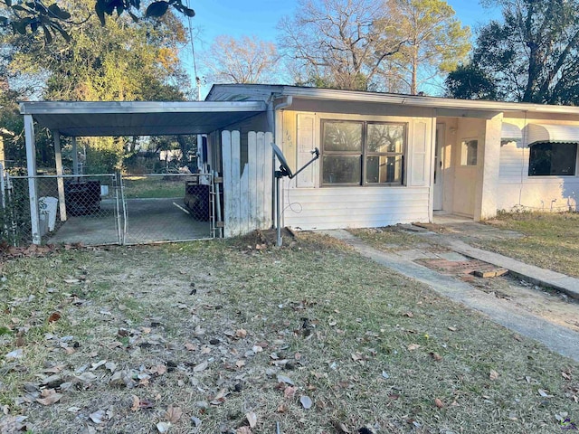 exterior space featuring a lawn and a carport