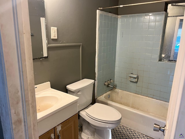 full bathroom featuring toilet, vanity, and tiled shower / bath