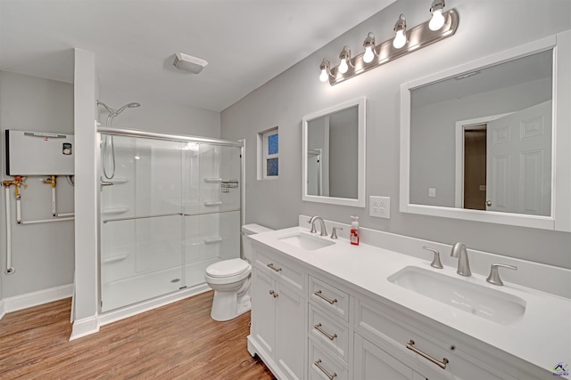 bathroom with toilet, hardwood / wood-style flooring, an enclosed shower, and vanity