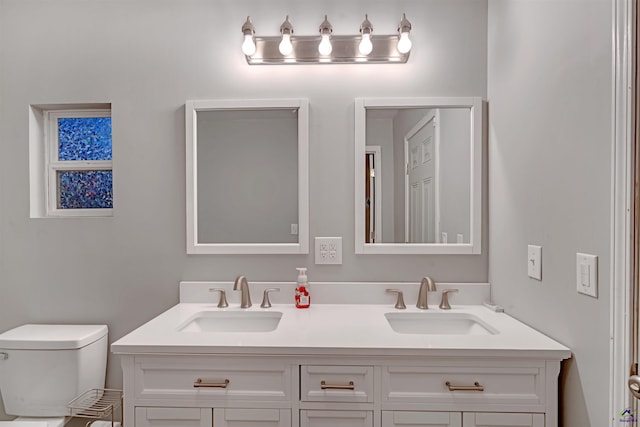 bathroom with toilet and vanity