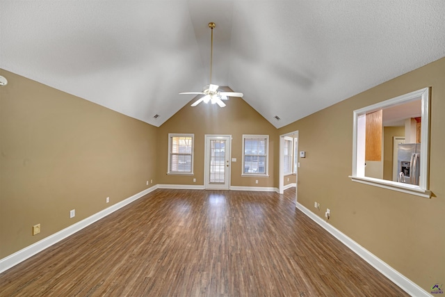 unfurnished living room with ceiling fan, vaulted ceiling, and hardwood / wood-style flooring