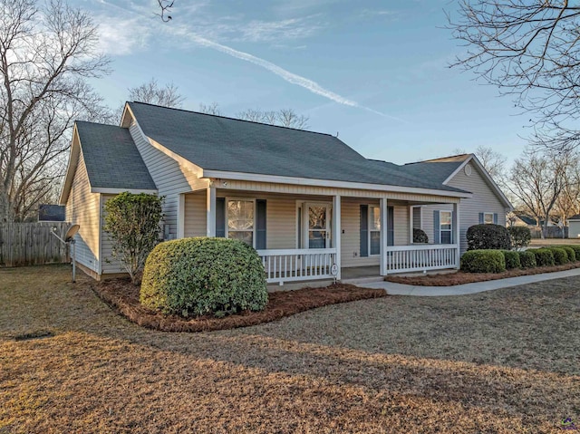 view of front of house with a porch and a front yard