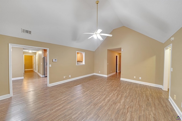 unfurnished living room with ceiling fan, light wood-type flooring, and lofted ceiling