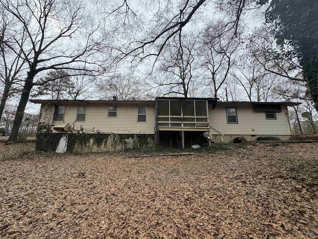 rear view of property with a sunroom