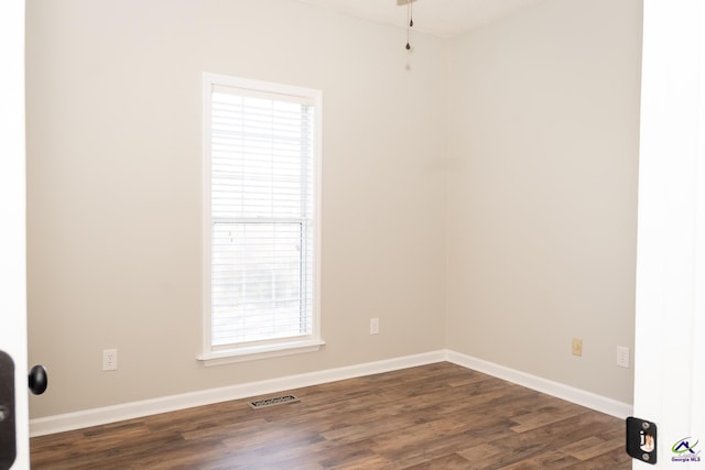 spare room with dark hardwood / wood-style floors