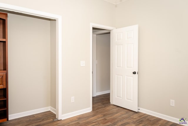 unfurnished bedroom with dark hardwood / wood-style floors