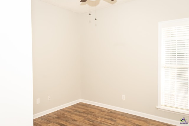 empty room with ceiling fan and dark wood-type flooring