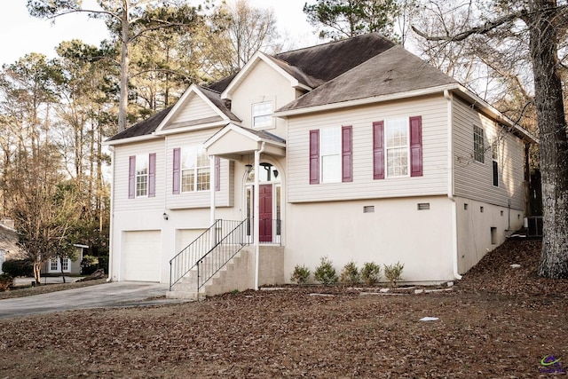 view of front of property featuring central AC unit and a garage