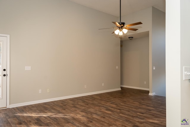 empty room featuring lofted ceiling, ceiling fan, and dark wood-type flooring