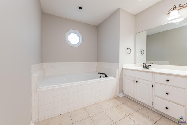 bathroom featuring tiled tub, tile patterned floors, and vanity