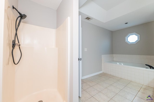 bathroom with separate shower and tub and tile patterned flooring