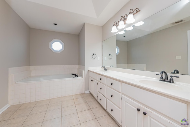 bathroom with vanity, tile patterned floors, and tiled tub