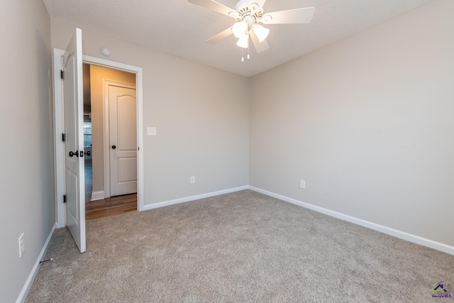 carpeted empty room with ceiling fan