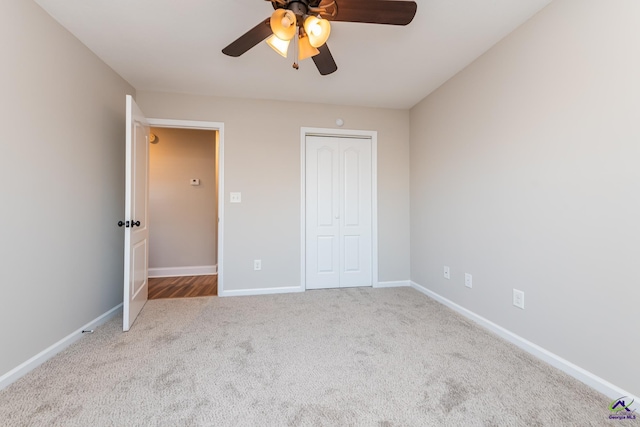 unfurnished bedroom with light carpet, ceiling fan, and a closet