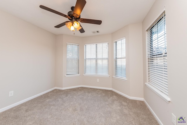 carpeted empty room featuring ceiling fan