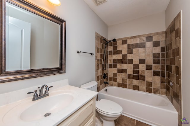 full bathroom with toilet, vanity, tile patterned flooring, and tiled shower / bath