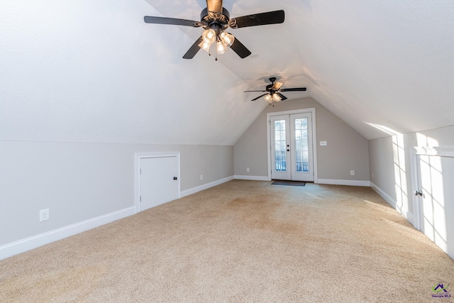 additional living space with light carpet, ceiling fan, lofted ceiling, and french doors