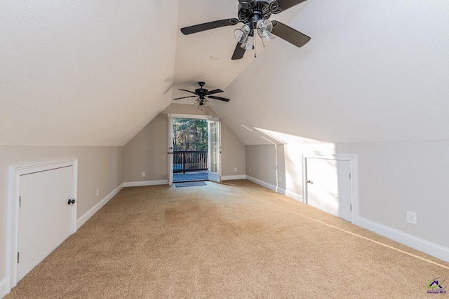 additional living space with ceiling fan, light colored carpet, and lofted ceiling