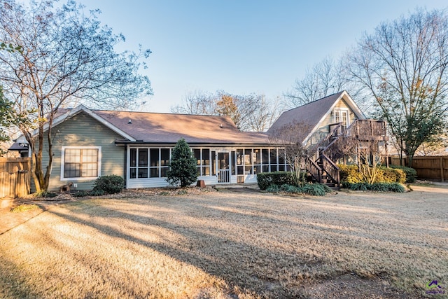 back of house featuring a sunroom and a yard