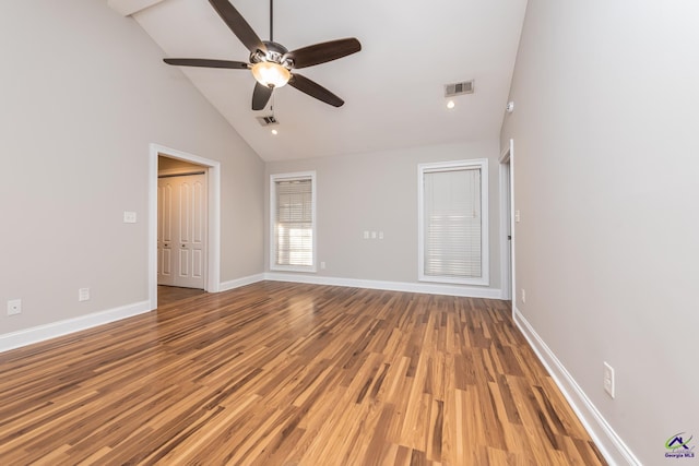 empty room with ceiling fan, wood-type flooring, and high vaulted ceiling