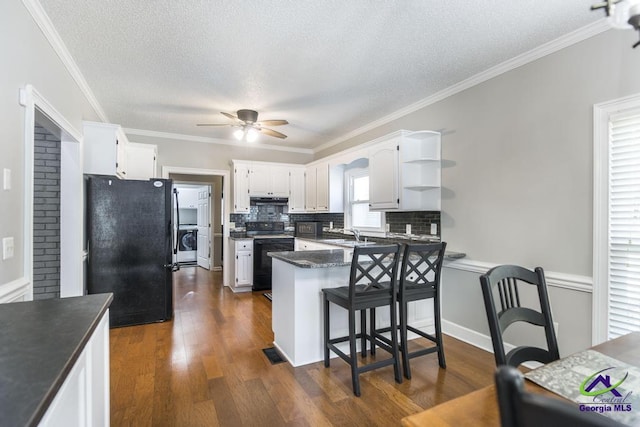 kitchen featuring a textured ceiling, kitchen peninsula, white cabinets, and black appliances