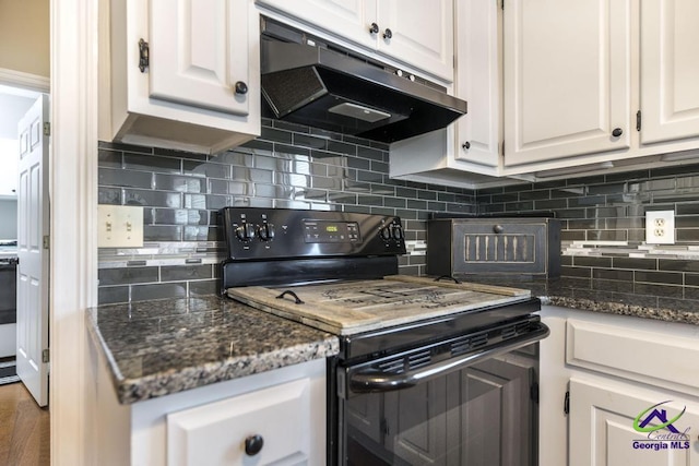 kitchen featuring decorative backsplash, white cabinets, electric range, and dark stone counters