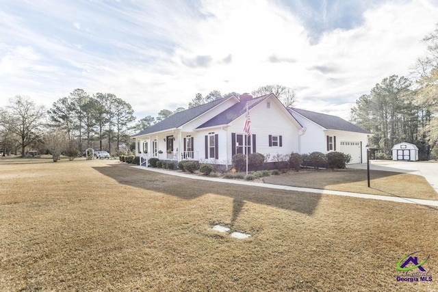 view of front of house with covered porch, a front lawn, and a garage