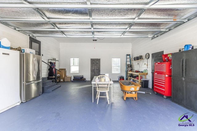 garage with stainless steel refrigerator