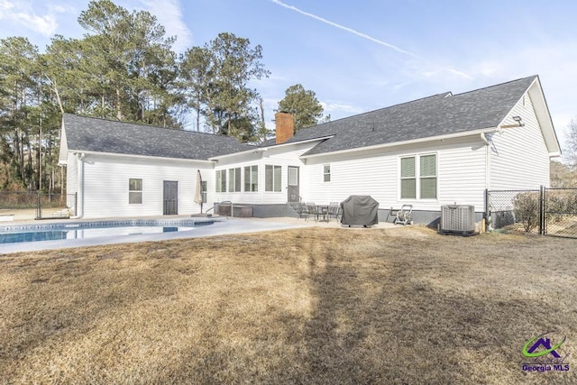 back of property featuring central AC unit, a lawn, and a patio