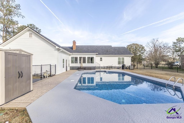 view of pool with a shed, cooling unit, and a patio