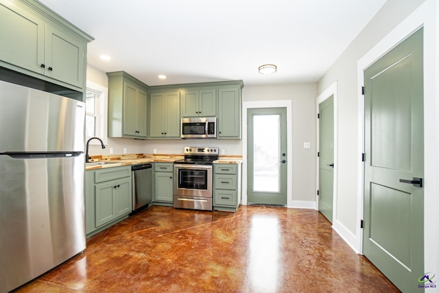 kitchen featuring sink, stainless steel appliances, and green cabinetry