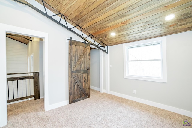 basement with carpet, wood ceiling, and a barn door