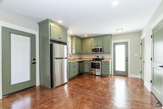 kitchen featuring sink, green cabinets, and stainless steel appliances